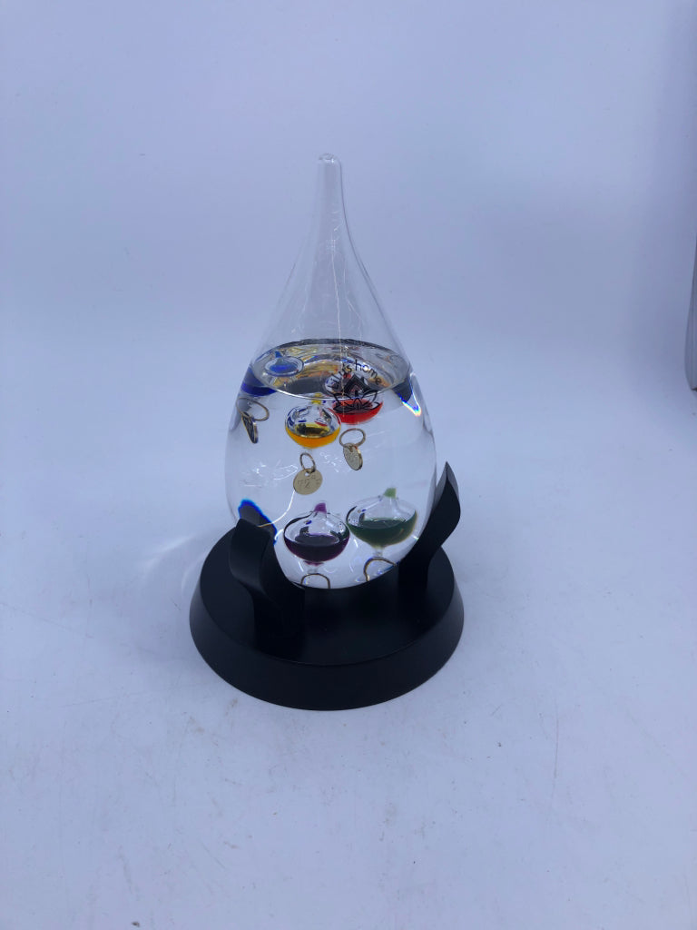 GLASS TEMPERATURE GAGE IN BLACK STAND.