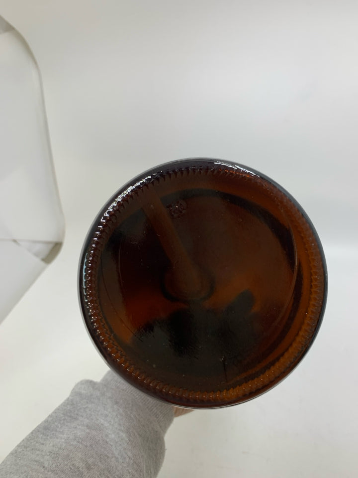 DARK BROWN GLASS 64 OZ JUG W/ PLASTIC PUMP.