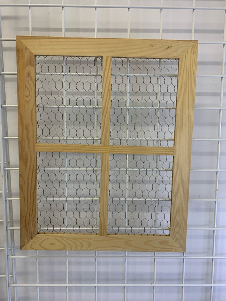 CHICKEN WIRE IN BLONDE WINDOW FRAME.