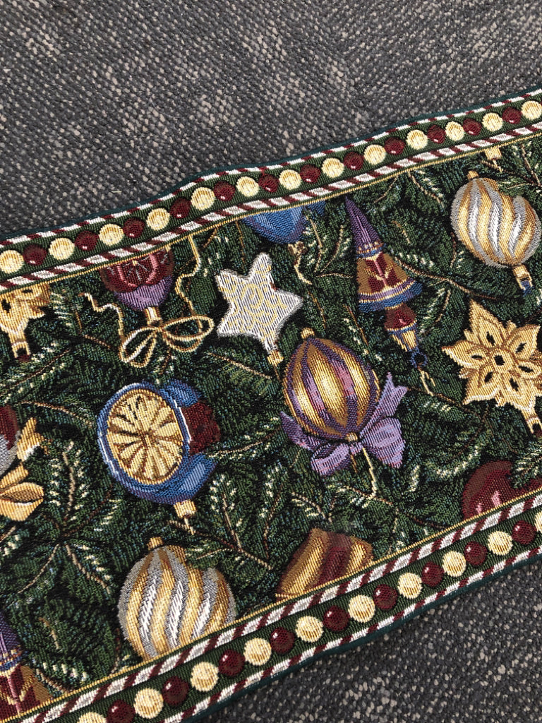 GREEN TABLE RUNNER WOVEN W/ COLORFUL ORNAMENTS.