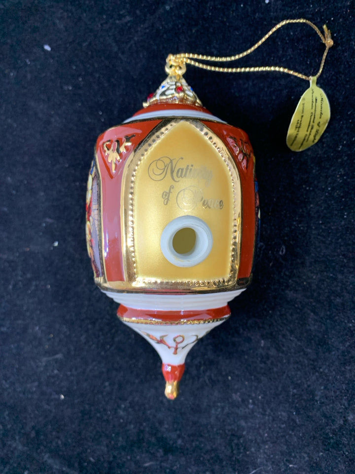 CERAMIC NATIVITY OF PEACE ORNAMENT.