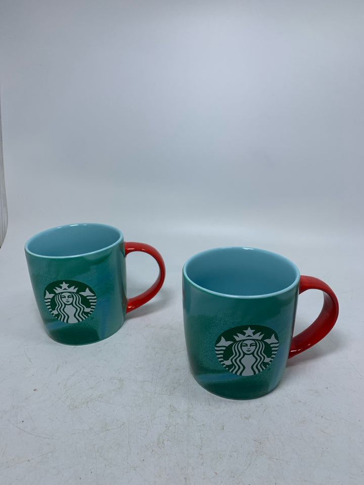 2 GREEN MARBLE MUGS W/ RED HANDLES.