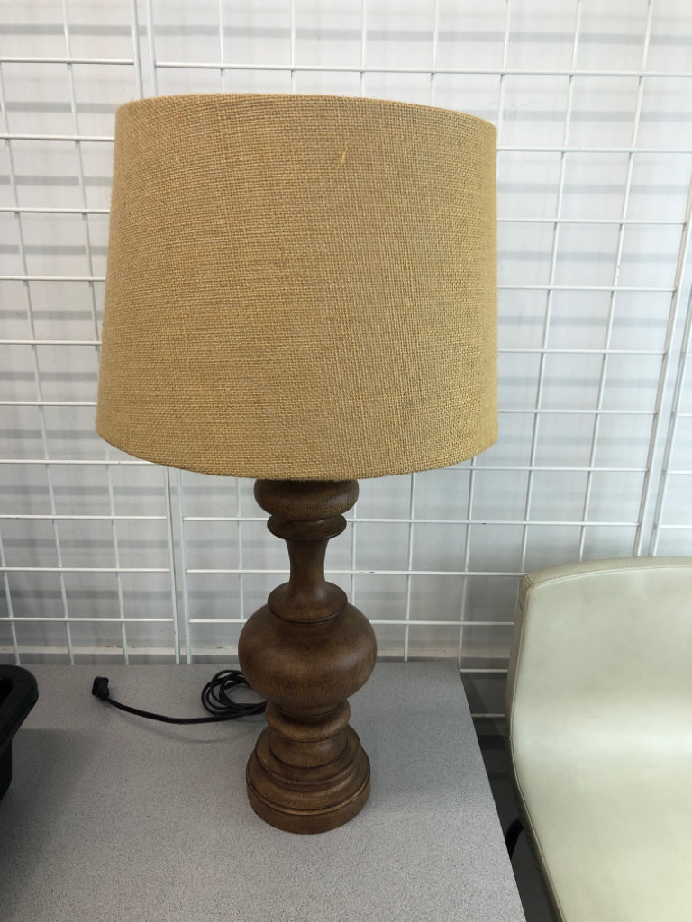 WOOD CARVED LAMP W/BURLAP SHADE.