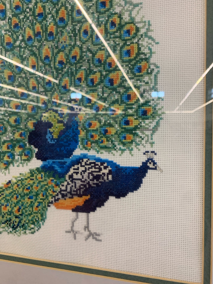 PEACOCK CROSS-STITCHED FRAMED ARTWORK.