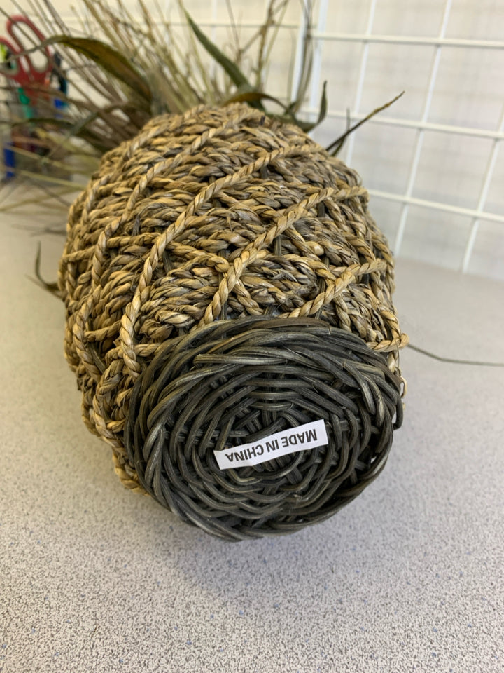 FAUX GRASS IN TWINE PLANTER.