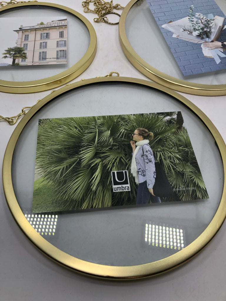 3 ROUND GOLD HANGING PHOTO HOLDERS.