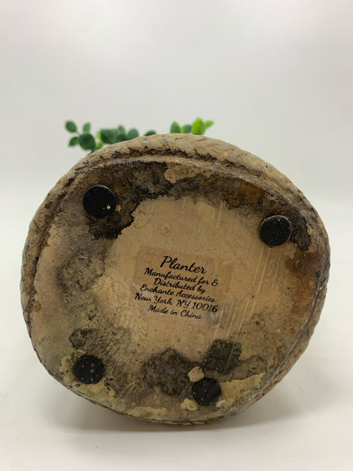 FAUX EUCALYPTUS IN RESIN BAG PLANTER.