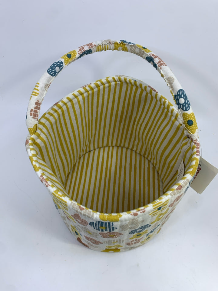 FLORAL FABRIC BIN W/YELLOW STRIPES ON INSIDE.