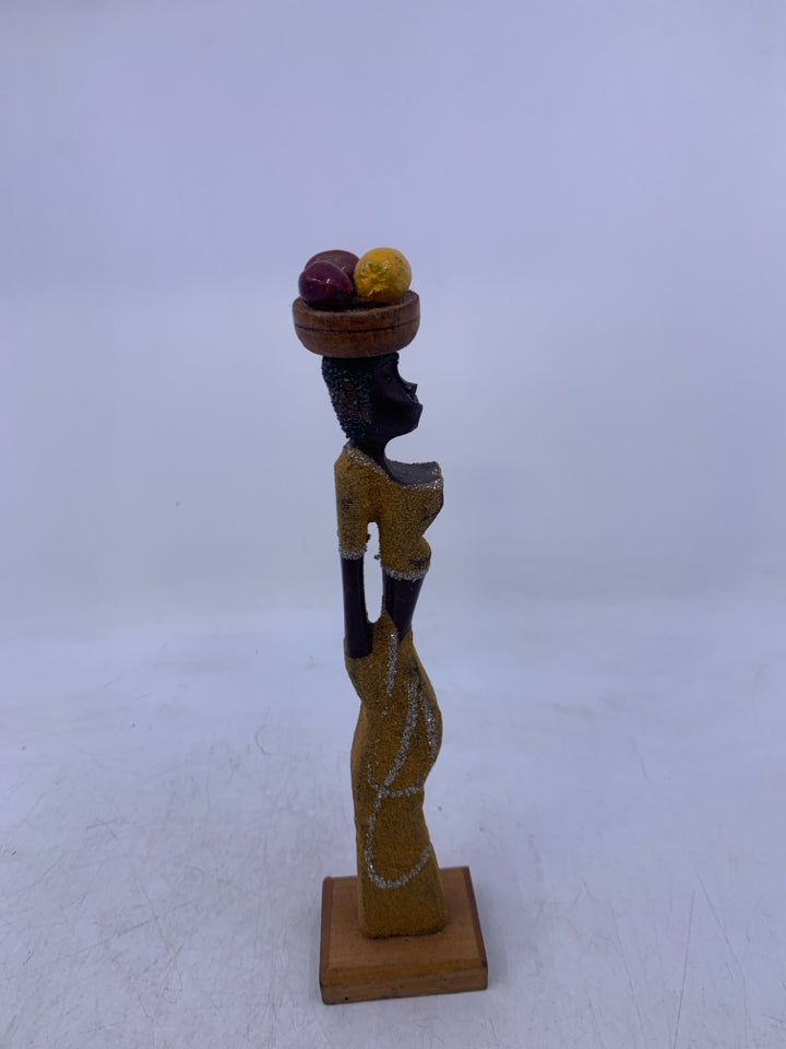 CARVED WOMAN CARRYING FRUIT ON HEAD.