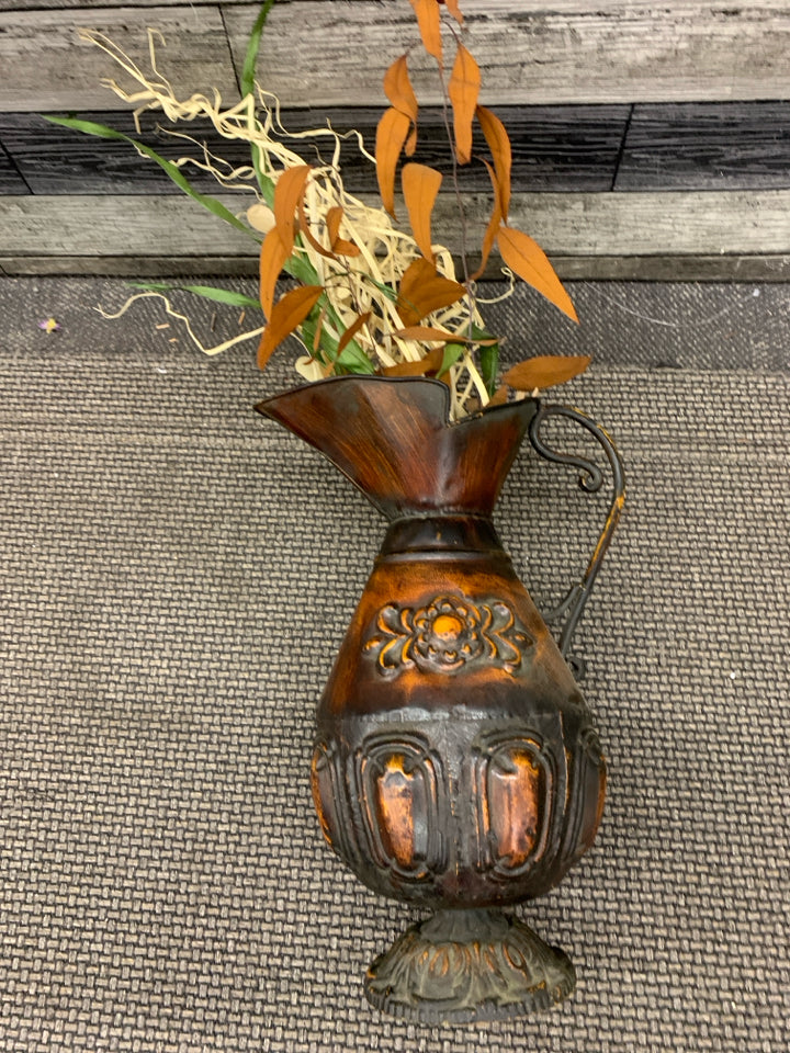 LARGE DISTRESSED METAL PITCHER W FAUX LEAVES.