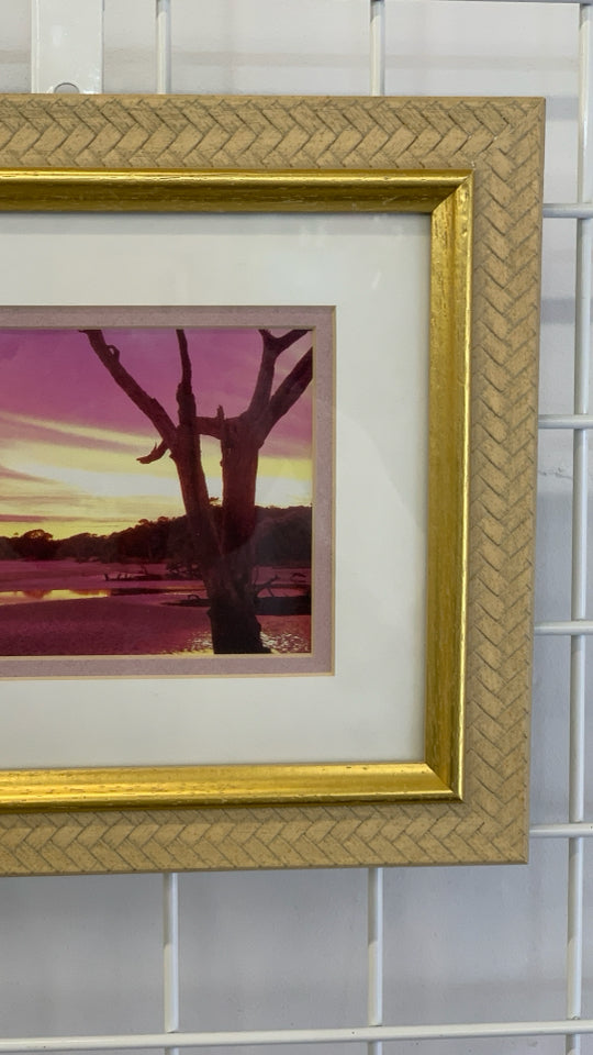 SUNSET PHOTO IN GOLD FRAME.