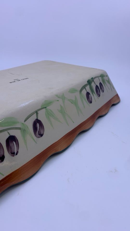 OLIVE CASSEROLE DISH IN METAL HOLDER.