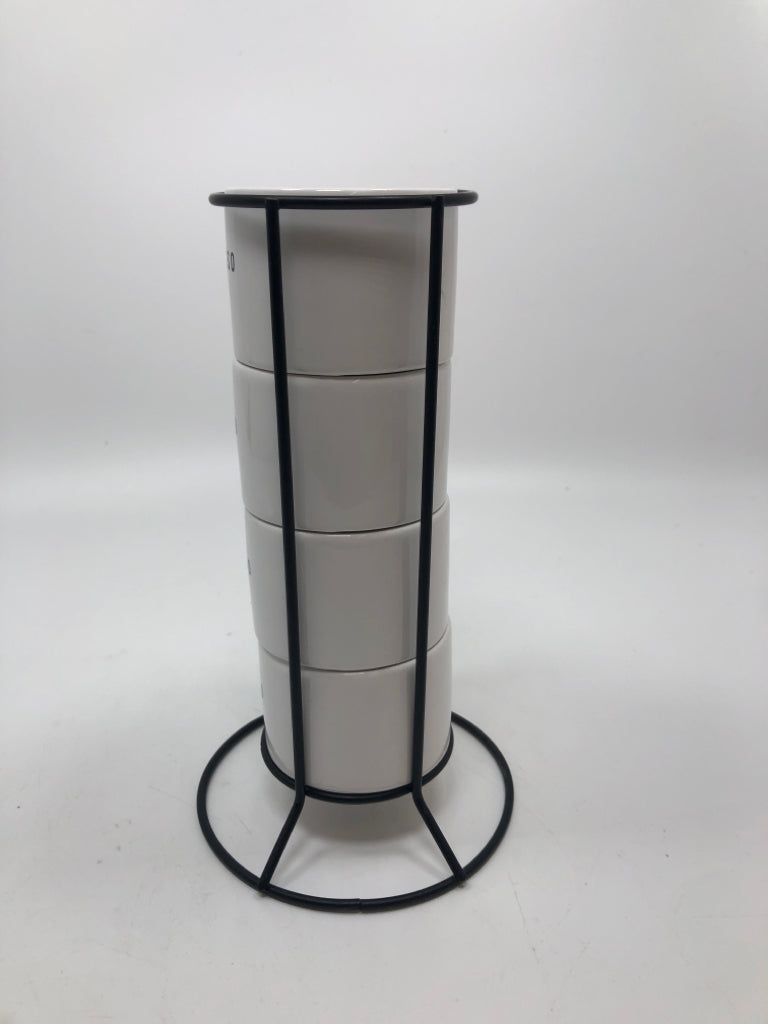 4 STACKED ESPRESSO CUPS IN BLACK HOLDER.