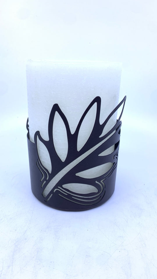 WHITE FAUX LIGHT UP CANDLE IN BROWN LEAF CANDLE HOLDER.