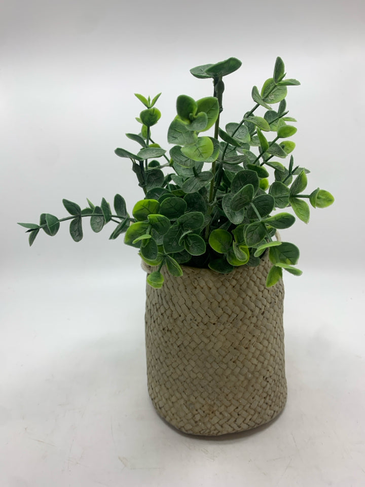 FAUX EUCALYPTUS IN RESIN BAG PLANTER.