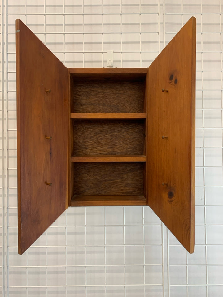 WOODEN WALL-SHELF W/ANGLED DOORS & HOOKS.