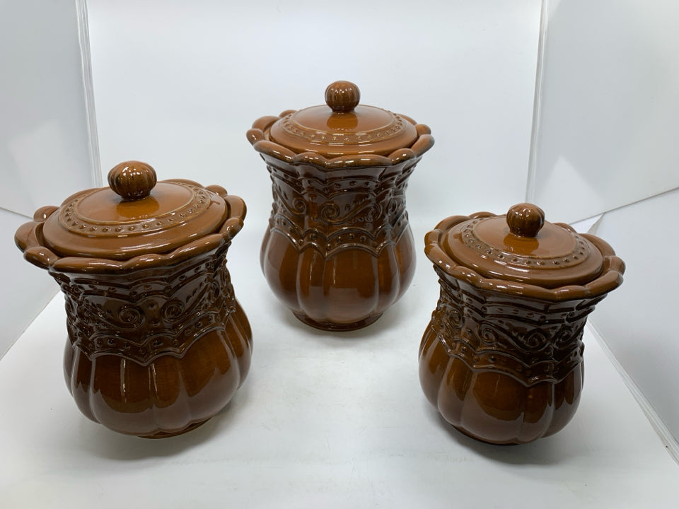 3 LIGHT BROWN SCROLL DETAILED CANISTERS.