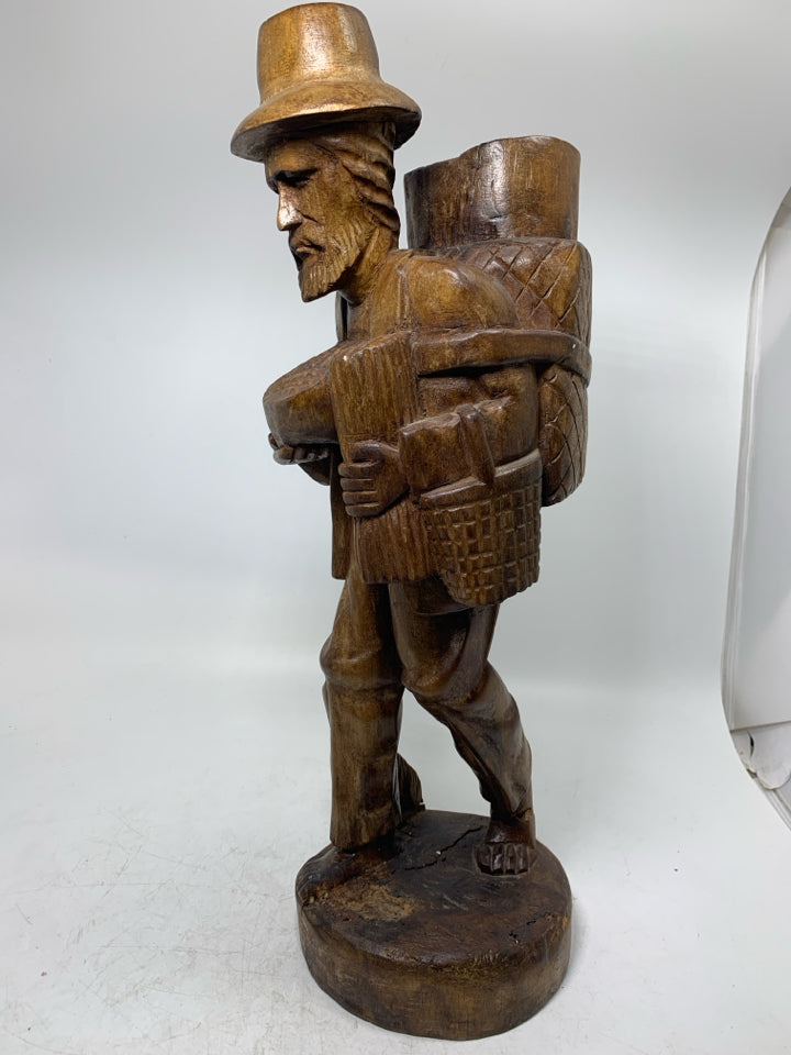 LARGE WOOD CARVED MAN W/ LARGE BACKPACK BAREFOOT WALKING.