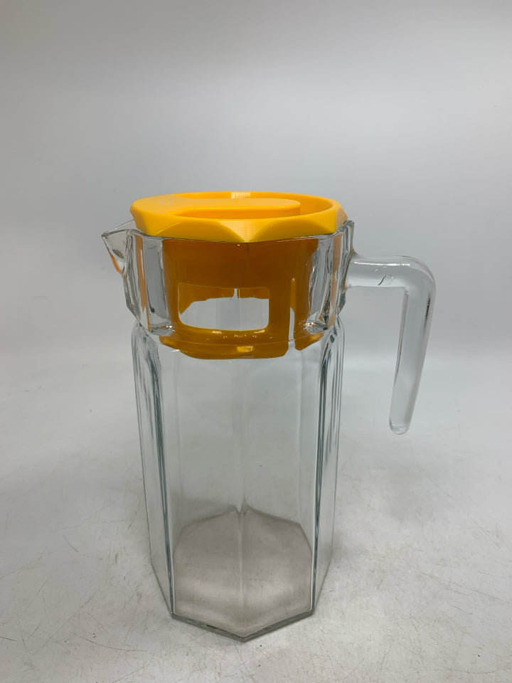GLASS OCTAGON SHAPE SHAPE PITCHER W/ YELLOW LID.