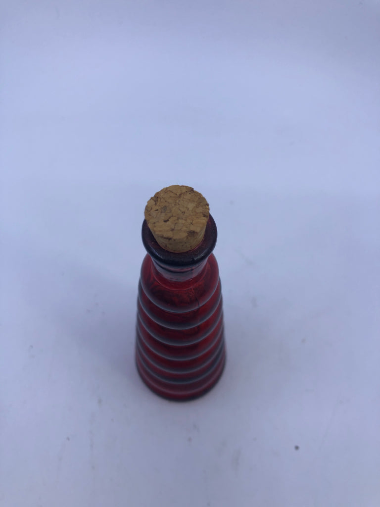 RED GLASS RIBBED BOTTLE W/CORK.