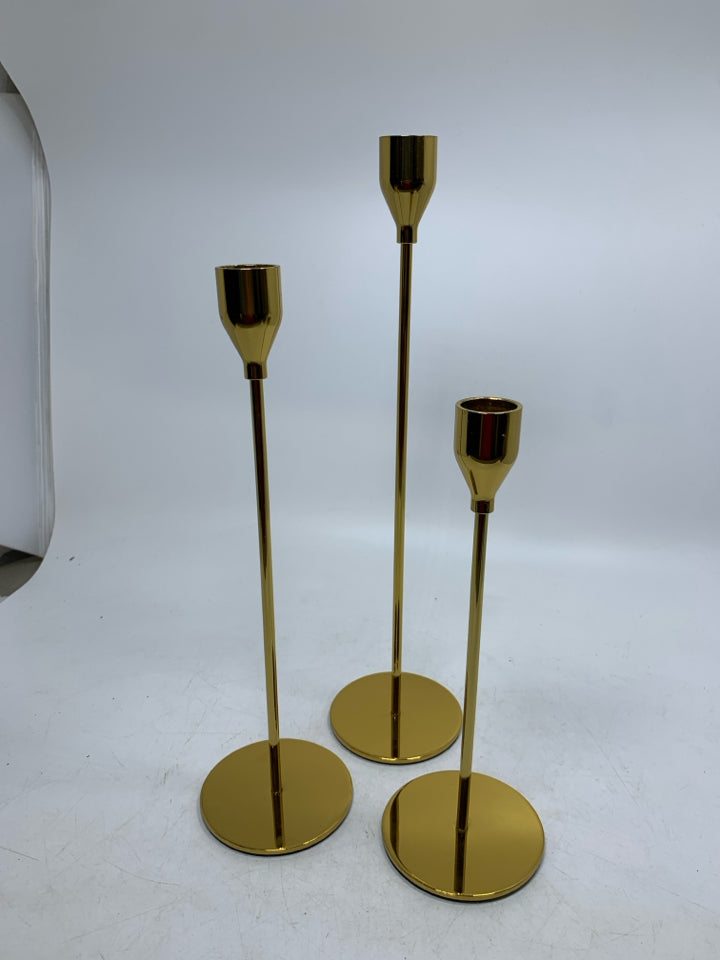3 GOLD SKINNY TAPERED CANDLE HOLDERS DIFFERENT SIZES.