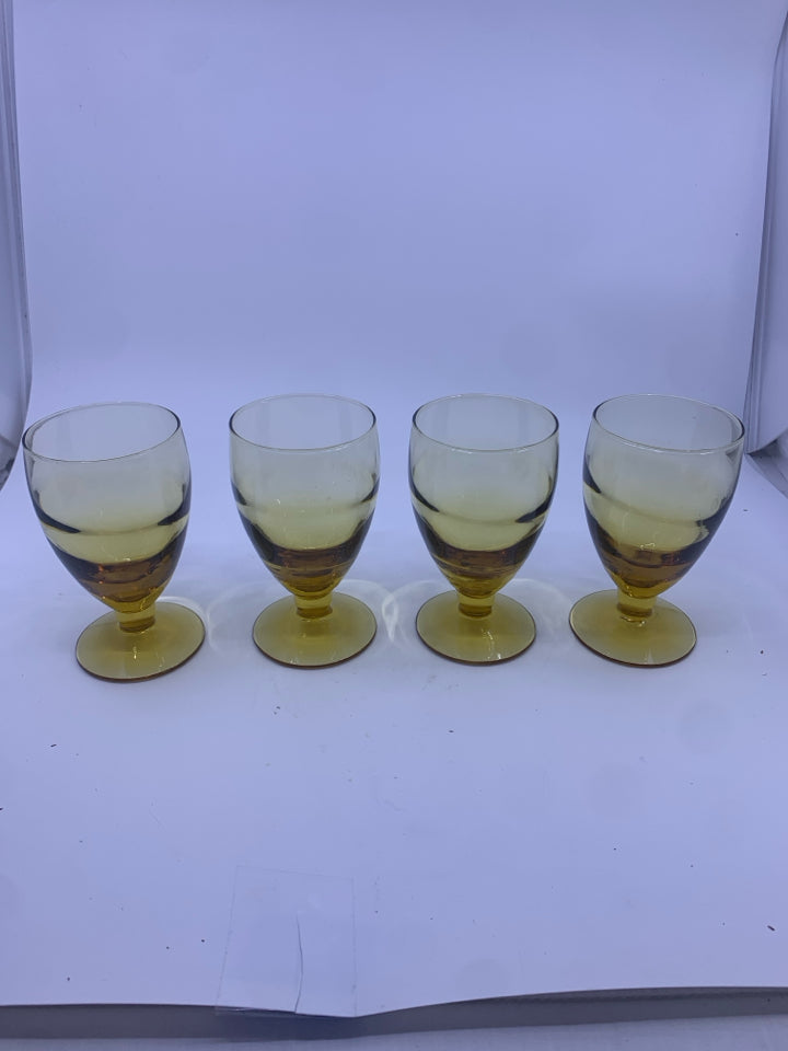 4 AMBER GLASS FOOTED GOBLETS.