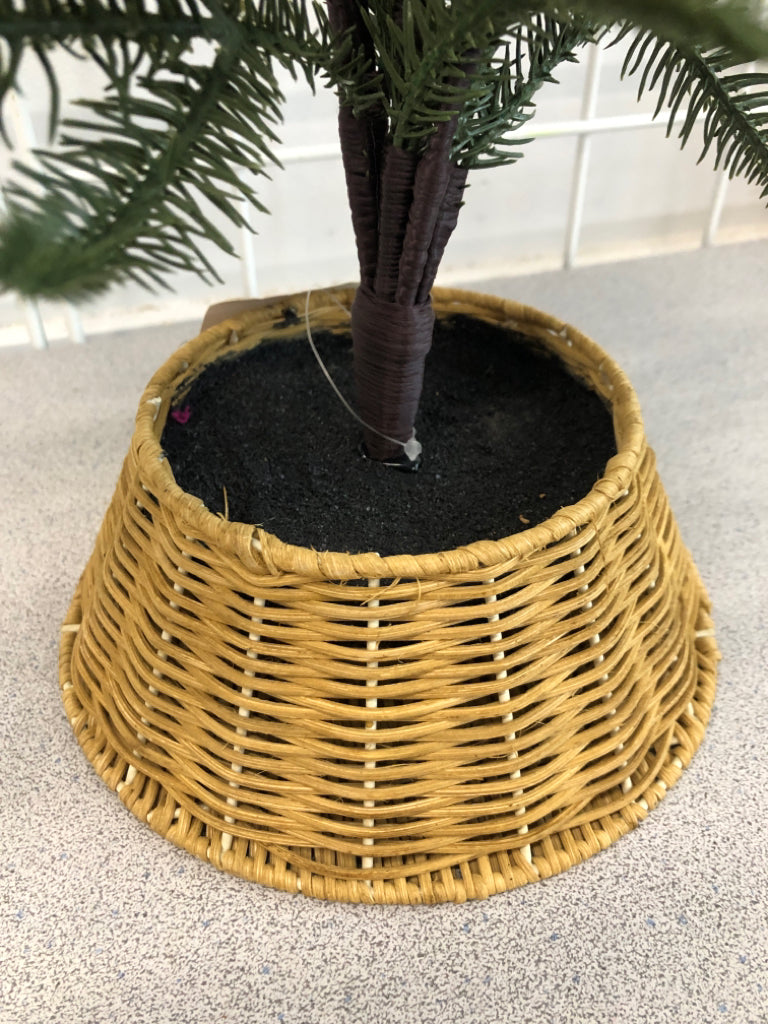 FAUX PINE TREE IN WICKER BASKET.