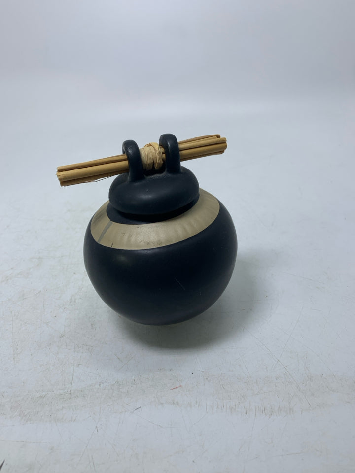 SMALL GINGER JAR W/ STICKS THROUGH TOP & SYBOLS.