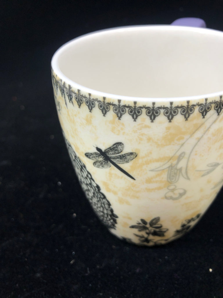 FLORAL MUG W PURPLE HANDLE.