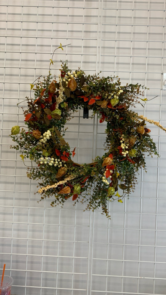 FAUX ORANGE AND GREENS WOVEN WREATH.