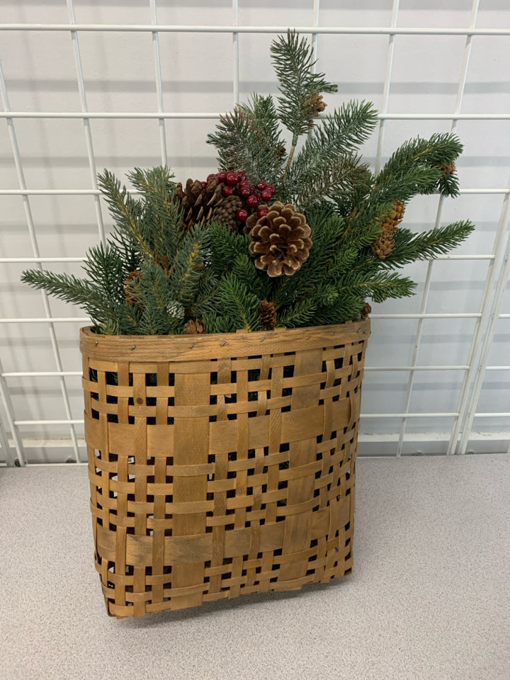 BROWN WOVEN WALL BASKET W/ FAUX PINE BRANCHES/PINECONES & BERRIES.
