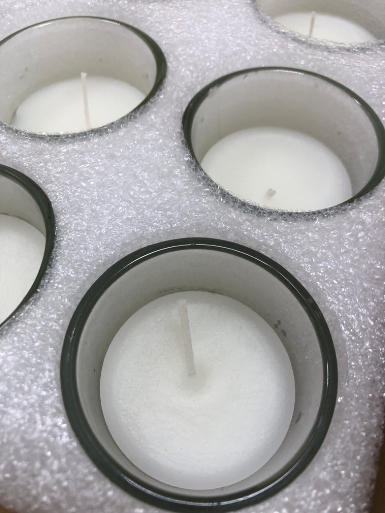 NIB 24PK UNSCENTED CLEAR GLASS VOTIVE CANDLES.