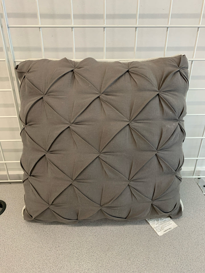 GREY RUFFLE PILLOW W/WHITE TRIM.