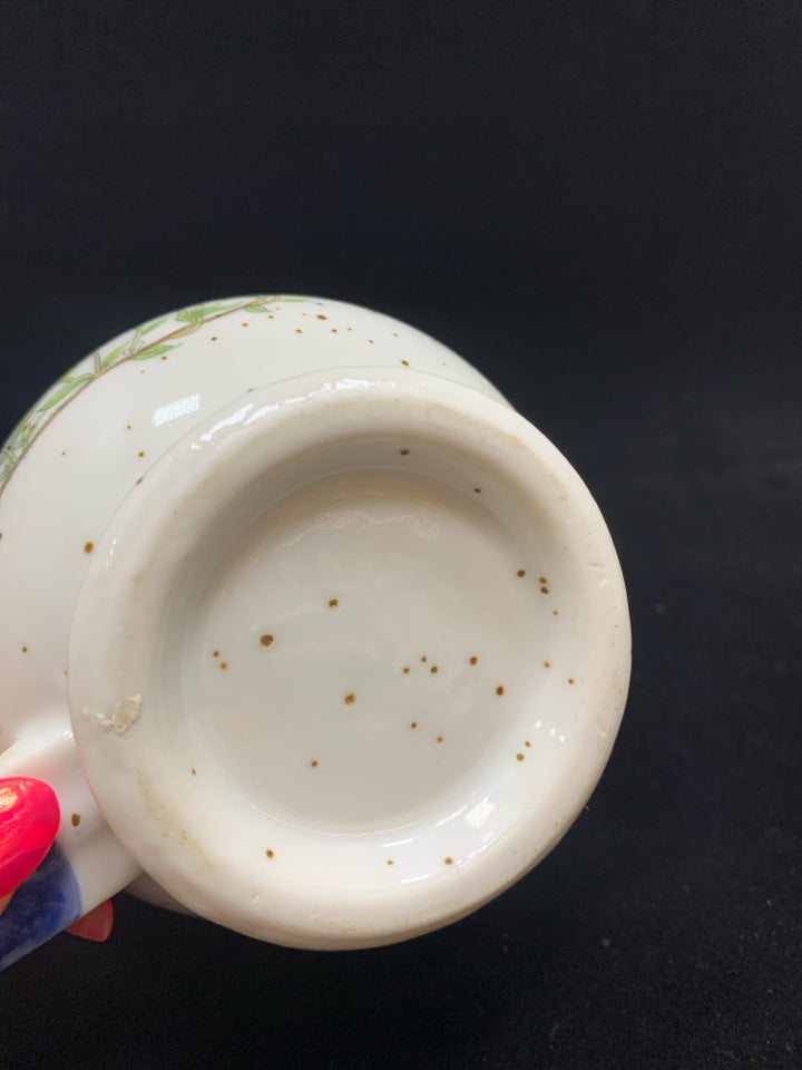 BLUE CERAMIC DOTTED MUG W/ORANGE FLOWERS.
