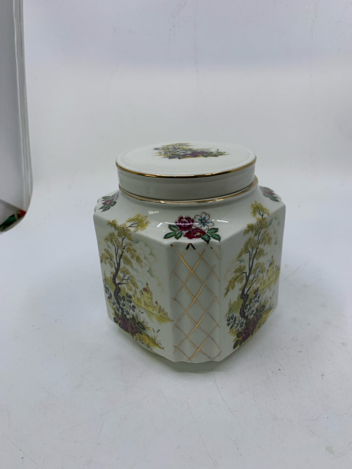 VTG WHITE SQUARE GINGER JAR W/ POND SCENE LOOKING OUT TO HOUSE GOLD DETAILS.