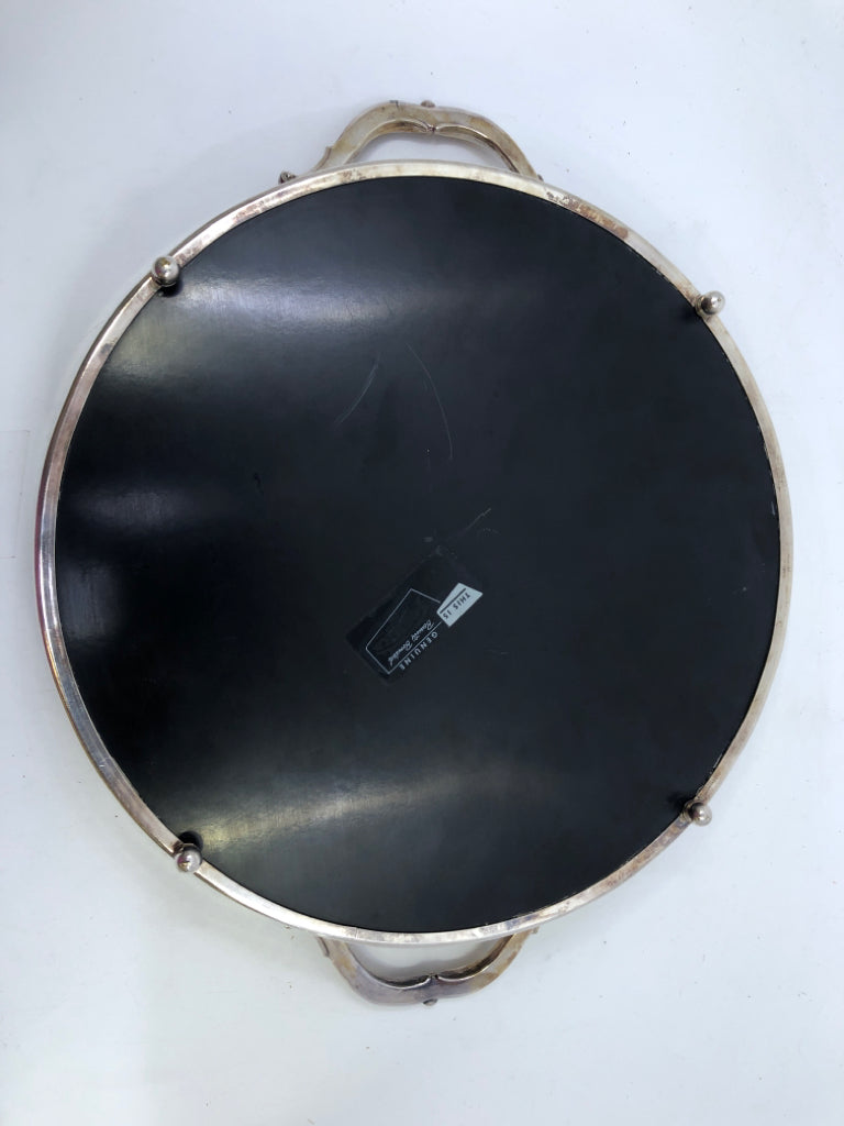 VTG SILVERPLATED FOOTED CIRCLE TRAY W/ BLACK BOTTOM FORMICA HANDLES.