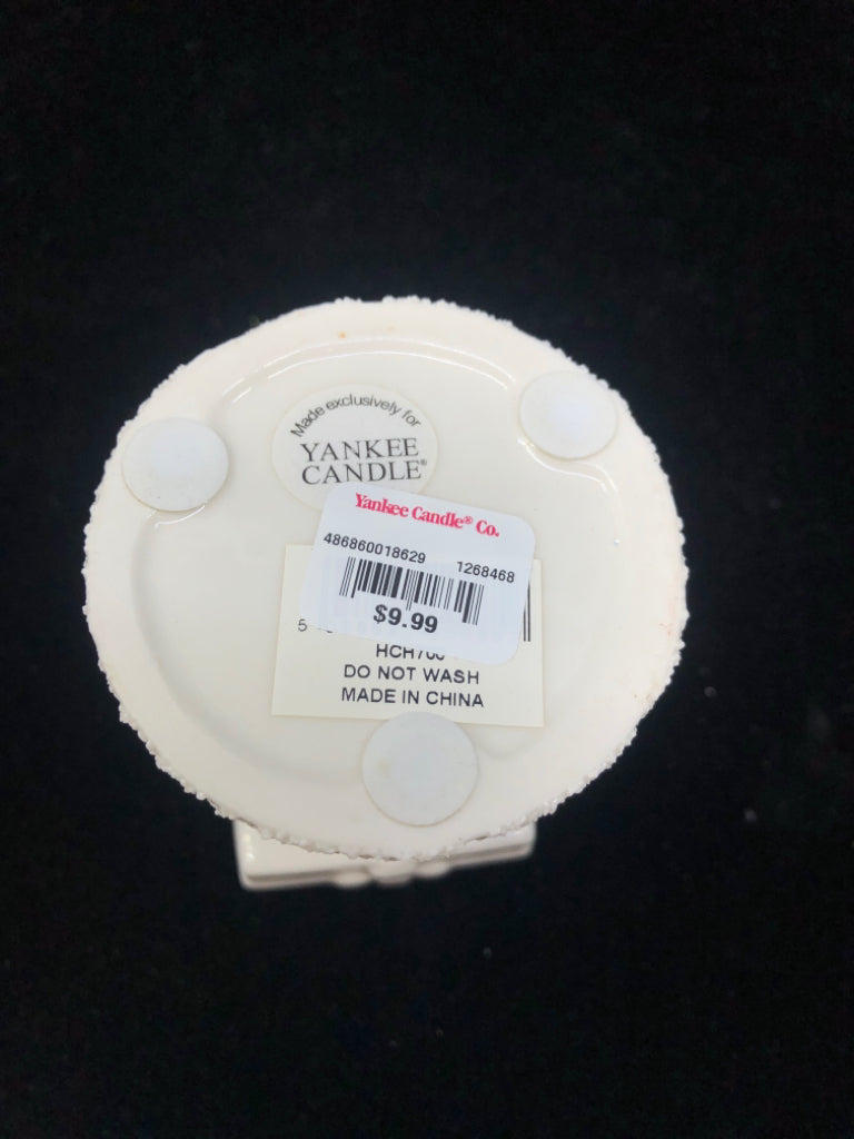 WHITE SANTA HOLDING PRESENT YANKEE CANDLE TEA LIGHT.