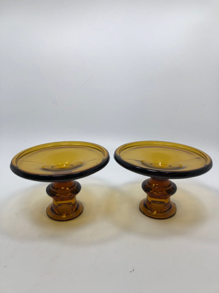 2 AMBER GLASS CANDLE STICK HOLDERS.