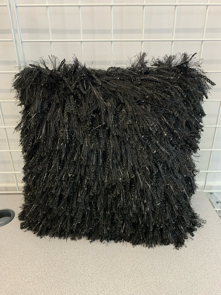 BLACK FURRY PILLOW W/TINSEL ACCENTS.