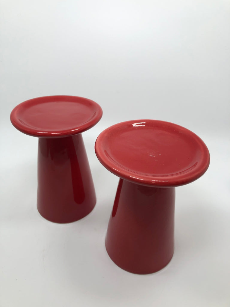 2 RED CERAMIC CANDLE HOLDERS.