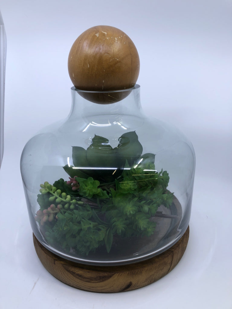 FAUX SUCCULENT TERRARIUM ARRANGEMENT ON WOOD BASE.