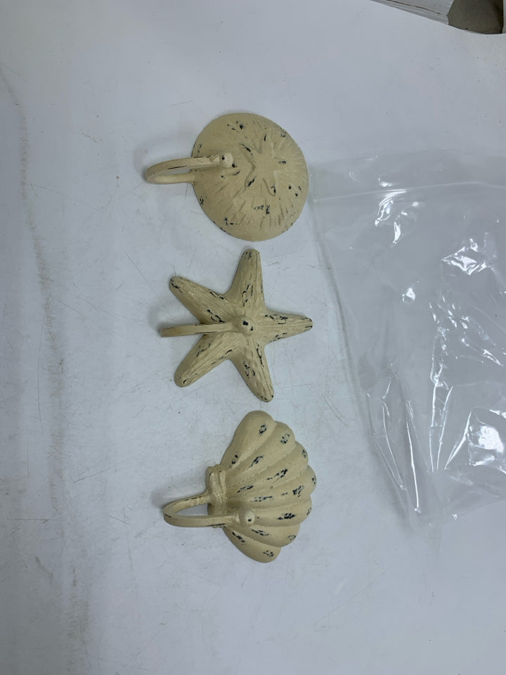 3 DISTRESSED CREAM METAL WALL HOOKS SEA THEMED IN BAG.