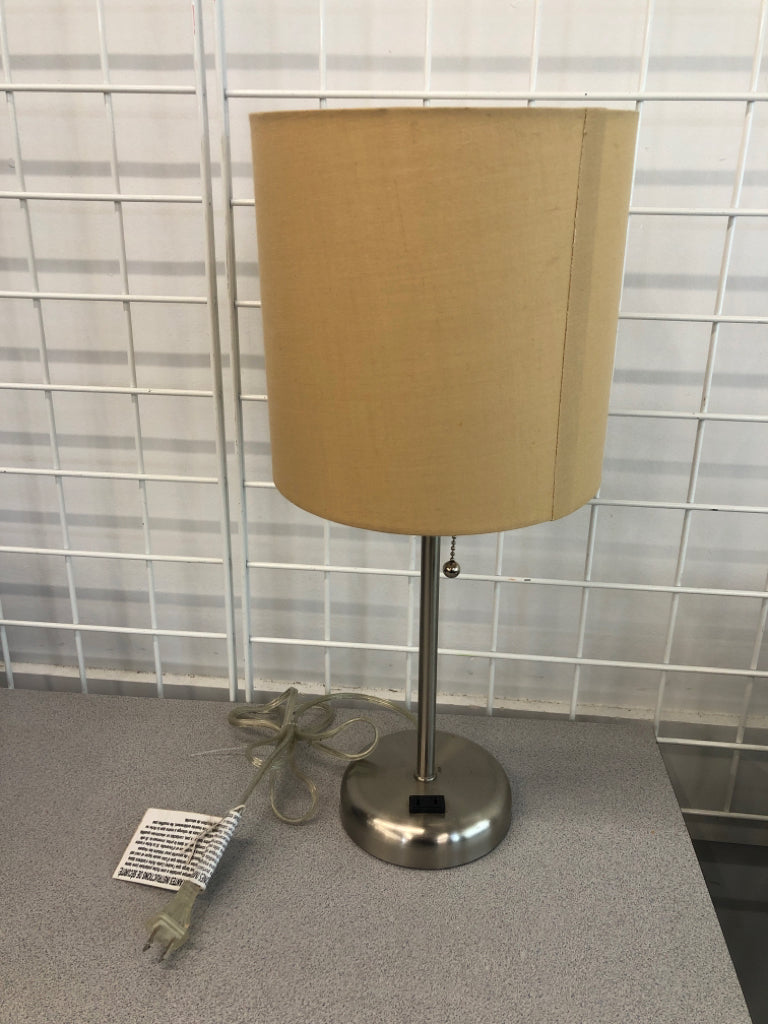 SILVER BASE OUTLET LAMP W/TAN SHADE.