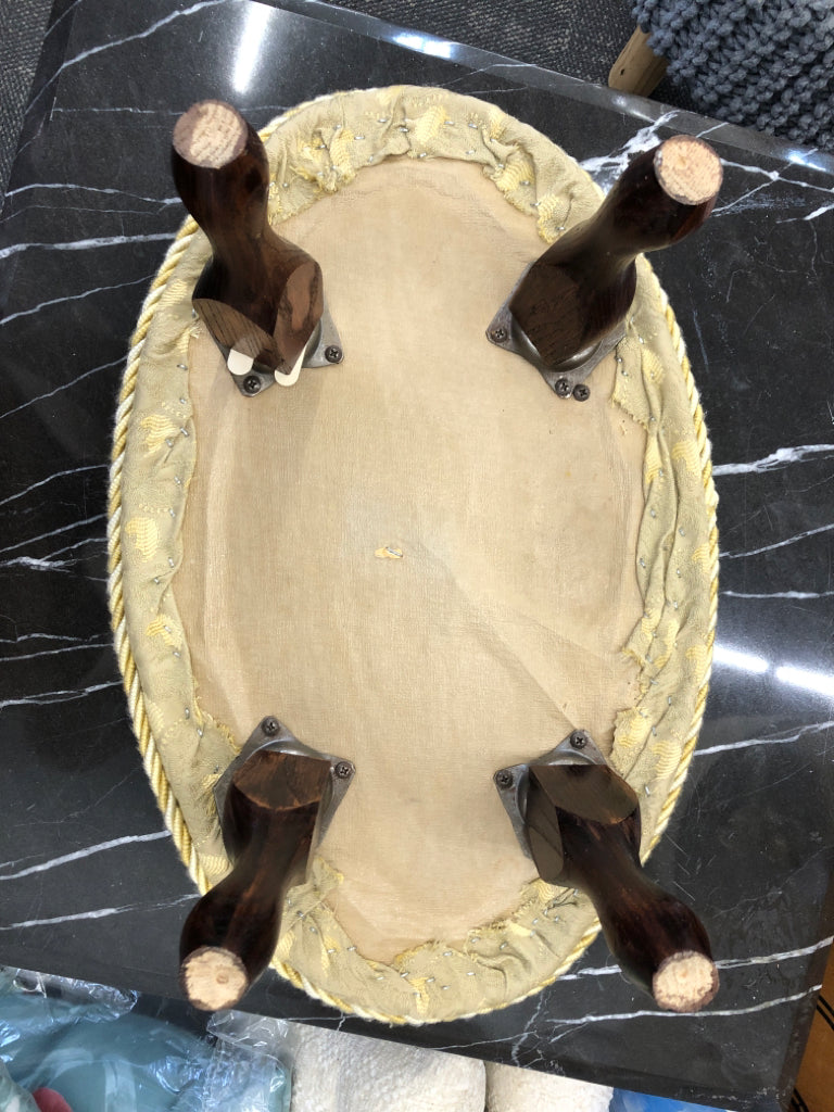 YELLOW FOOT REST FLORAL PATTERN W/TWISTED CHORD EDGE & DARK WOOD FEET.
