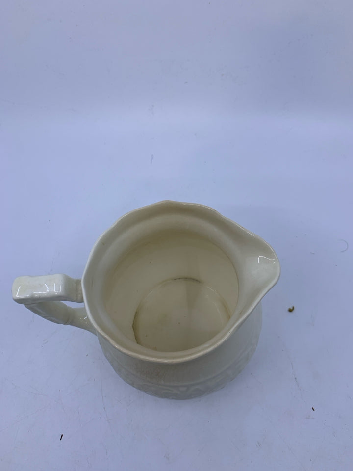SMALL EMBOSSED PITCHER.