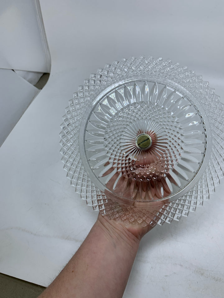 GLASS PLATE W/ METAL HANDLE IN CENTER.