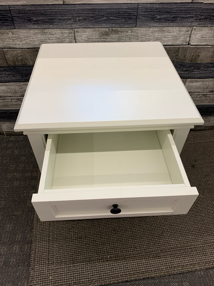 WHITE NIGHT STAND W/ DRAWER BLACK HARDWARE.