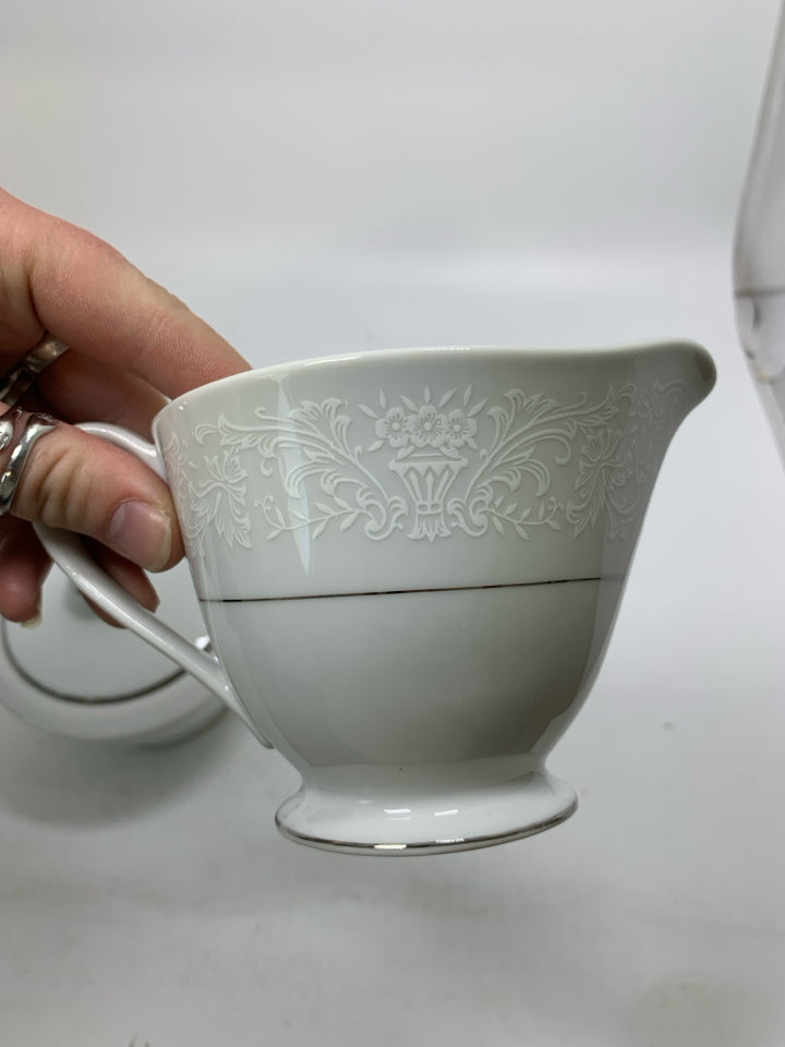 FOOTED WHITE LACE PORCELAIN CREAM/SUGAR SET W/ SILVER DETAILED.