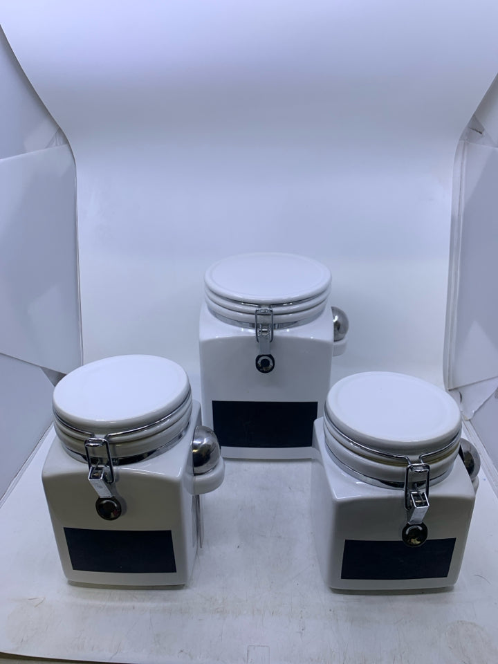 3 PC WHITE CANISTER SET W/ CHALK BOARD LABEL AND METAL SPOONS.