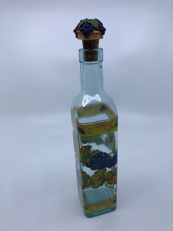 OLIVE OIL GLASS CONTAINER W/ GRAPES ON TOP OF CORK.